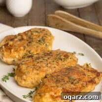 Crispy, golden breaded chicken cutlets topped with a light shallot and thyme glaze, served on a white platter with fresh green beans in the background.