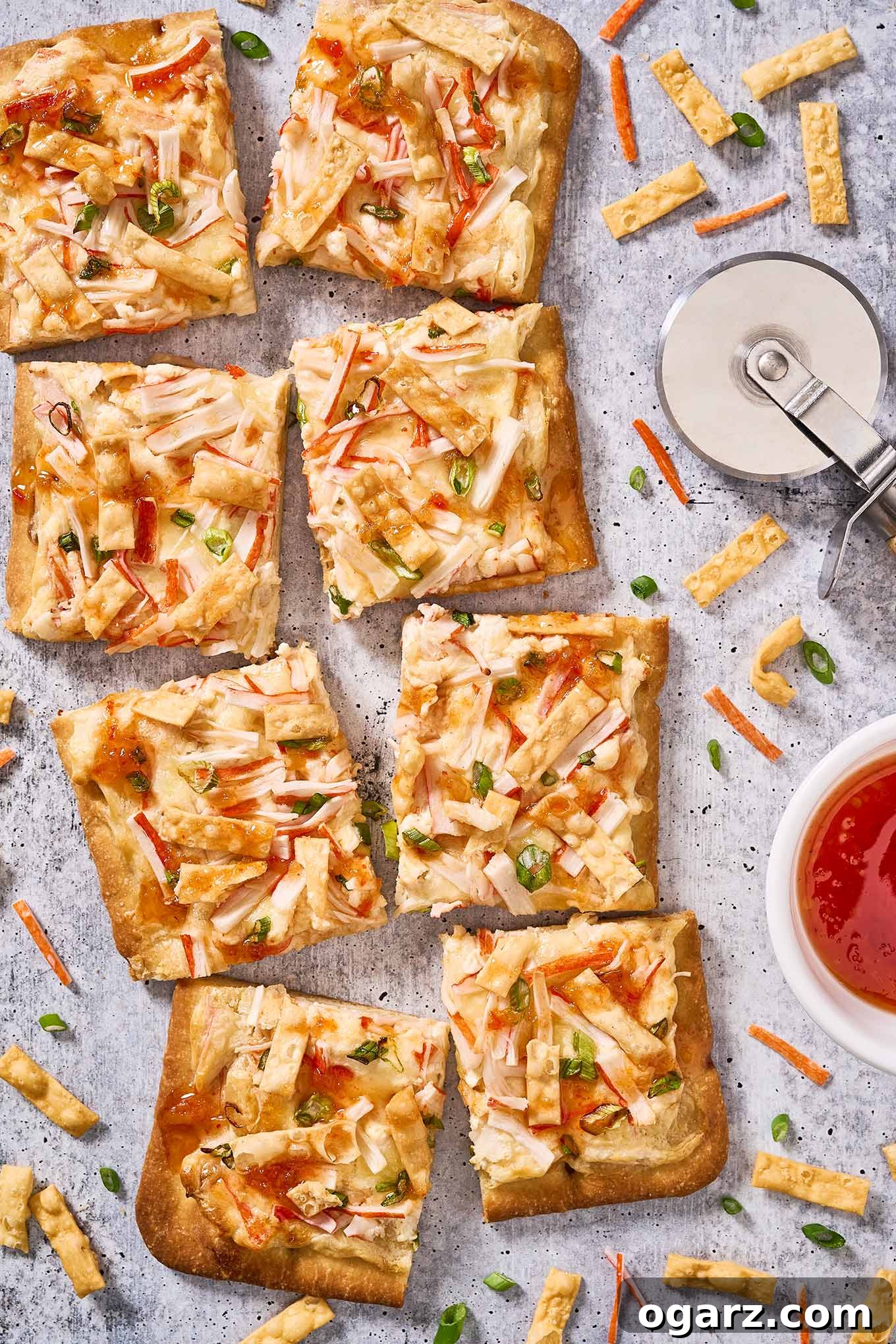 Crab Wonton Pizza 7 A whole crab Rangoon flatbread cut into eight squares for serving with the pizza cutter off to the right side.