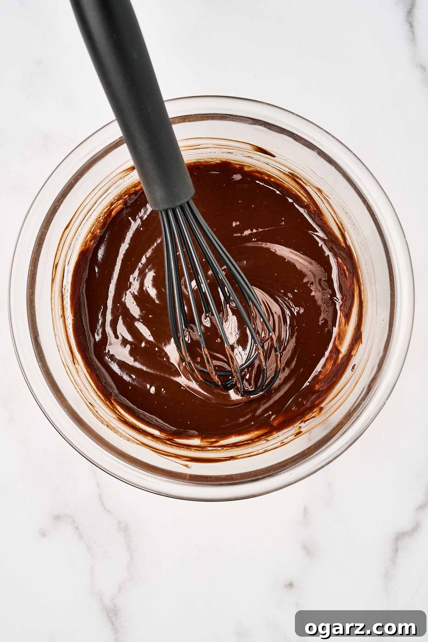 S'mores Parfaits 5 An overhead view of smooth, silky chocolate ganache in a mixing bowl with a whisk.