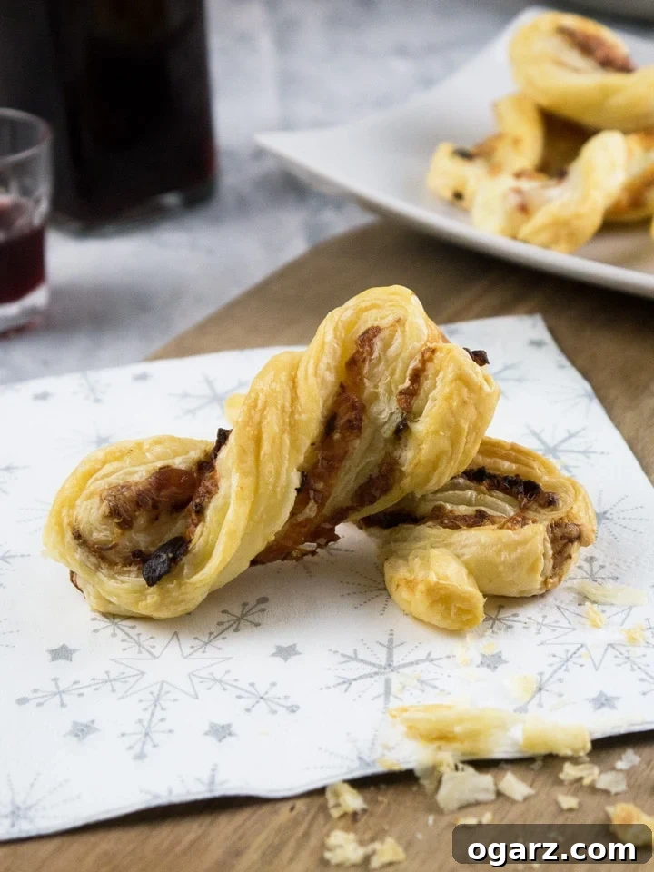 Crispy golden brown Bacon & Cheese Puff Pastry Twists on a serving platter, perfect for parties.