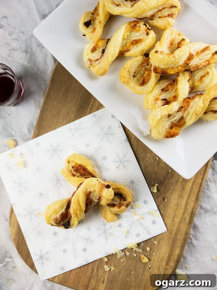 Close-up of a single perfectly twisted and baked Bacon & Cheese Puff Pastry Twist.