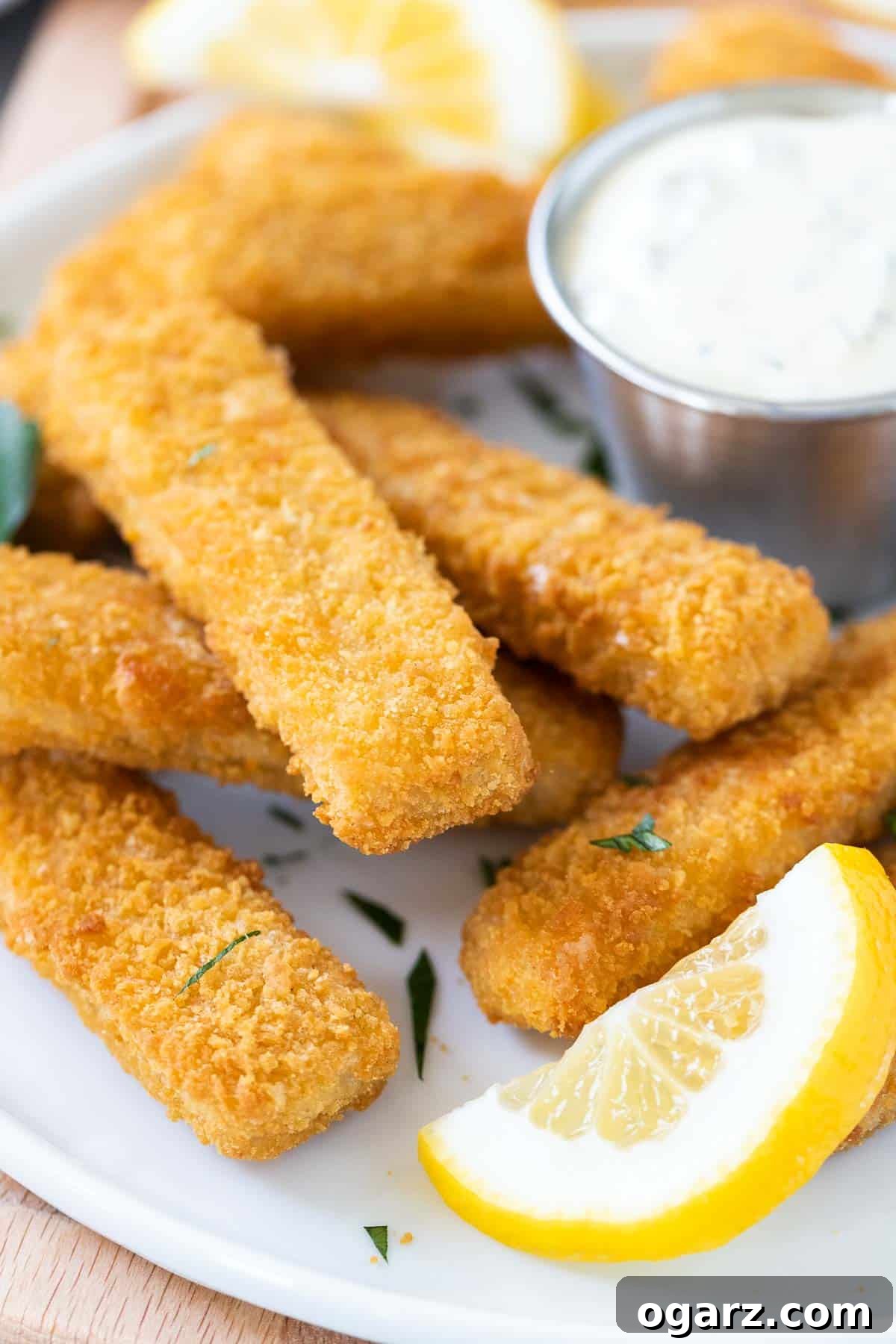 Crispy Air Fryer Fish Sticks 6 A detailed close-up shot of a single golden-brown, perfectly crispy Air Fryer fish stick, highlighting its texture.