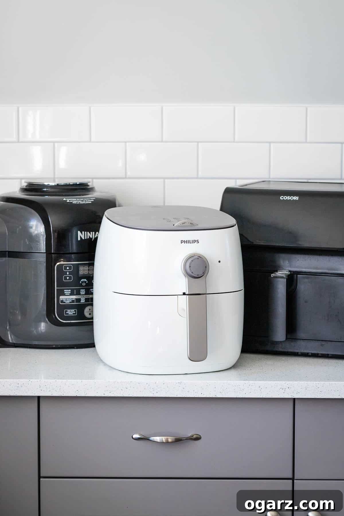 What's the Best Air Fryer for You 2 Three different types of air fryers displayed on a modern kitchen counter, ready for cooking