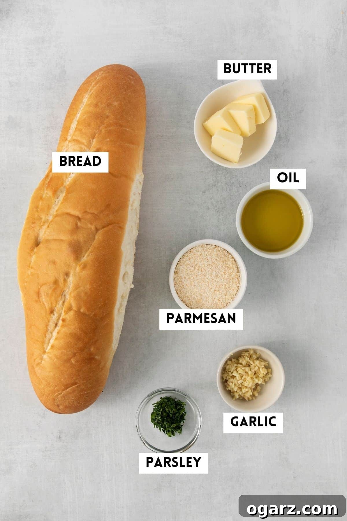 Air-Fried Garlic Bread Perfection 3 Various ingredients for making homemade garlic bread, including a loaf of bread, butter, olive oil, garlic, and parsley.