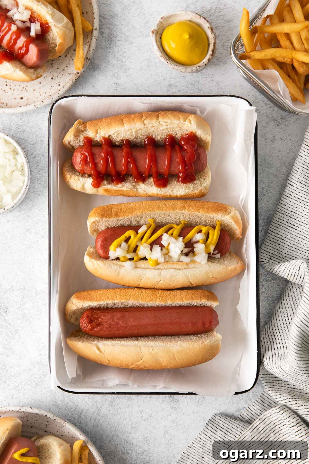 Golden Crispy Air Fryer Hot Dogs 6 Three air fryer hot dogs with various gourmet toppings arranged on a serving platter, ready to be enjoyed.