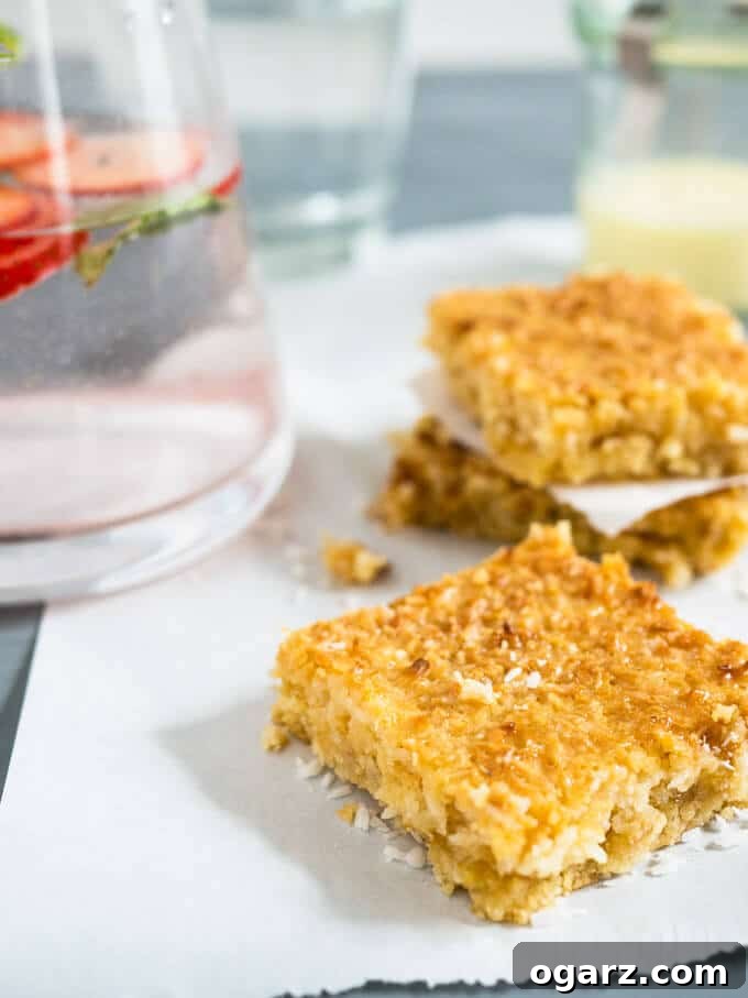 Detailed shot of the golden, caramelized crust of Tropical Coconut Squares, showcasing the rich texture.