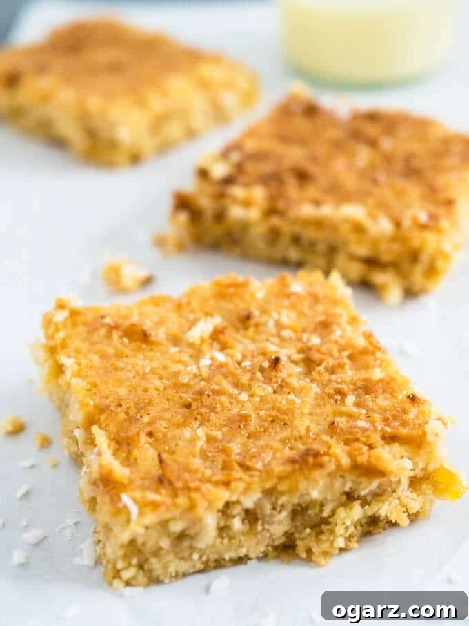 A beautifully arranged stack of Tropical Caramel Coconut Squares, ready to be enjoyed as a sweet and satisfying dessert.