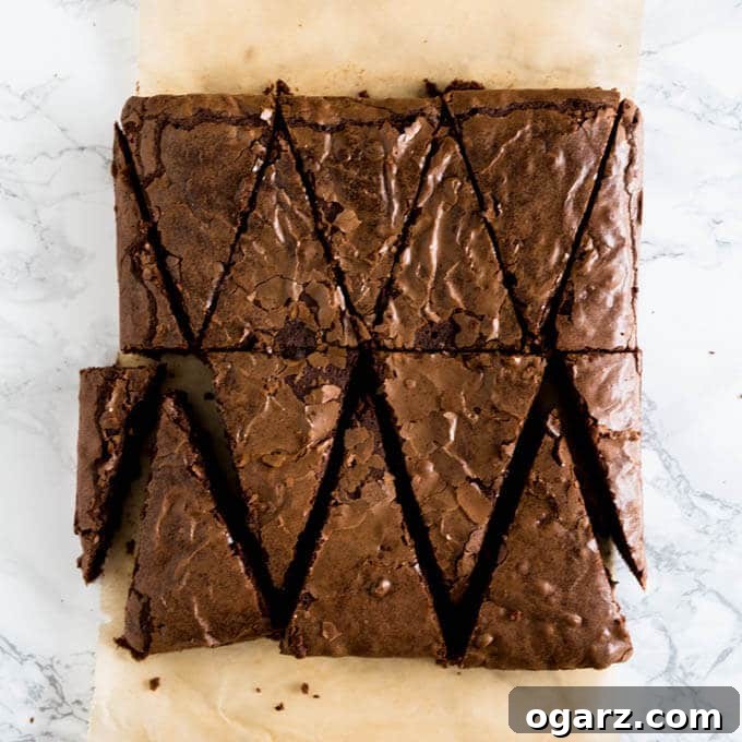 Festive Gingerbread Brownies 4 A square brownie tray cut into triangular shapes to resemble Christmas trees, with leftover pieces on the side.