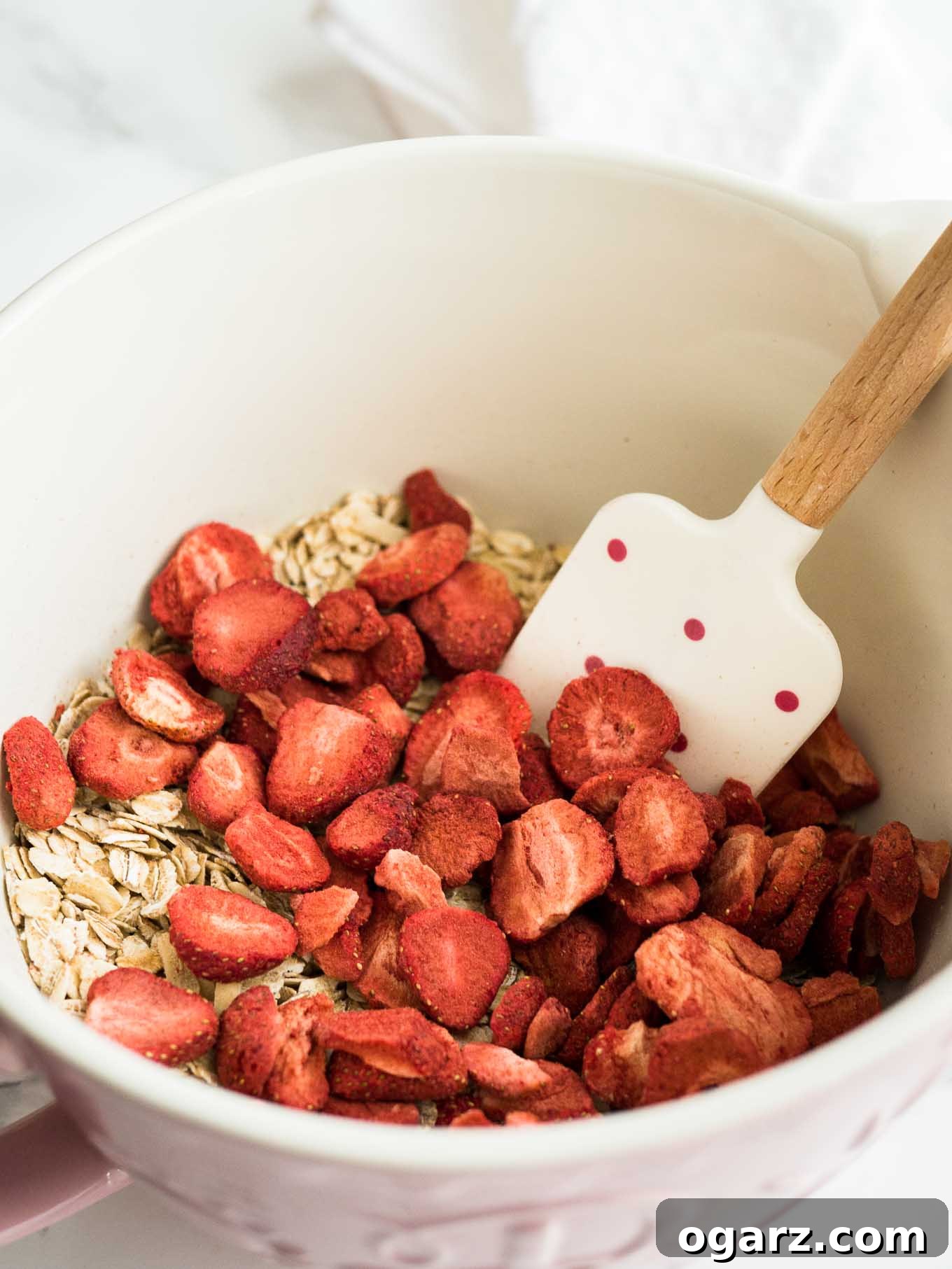 Healthy Strawberry Baked Oatmeal Cups 3 Close-up of a single Strawberry Baked Oatmeal Cup, showcasing the texture and visible pieces of freeze-dried strawberries.