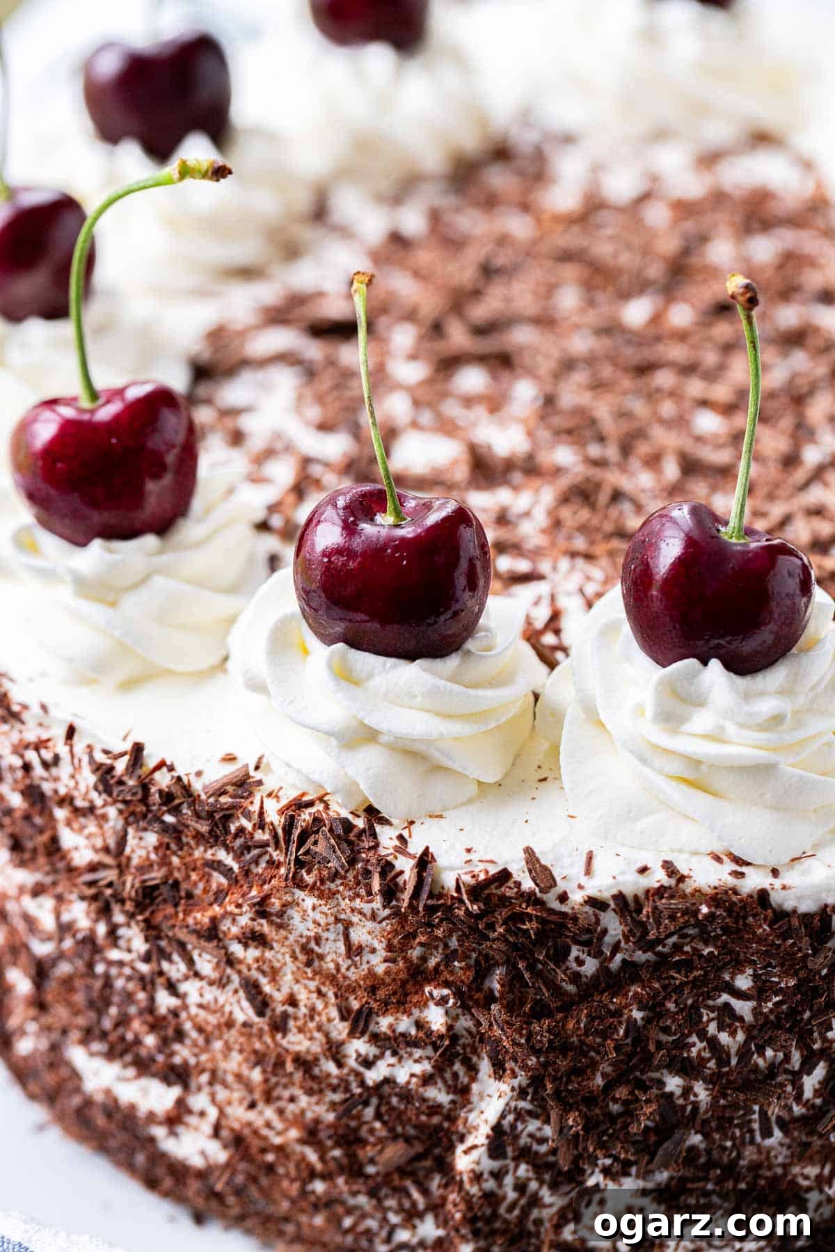 Dark Forest Cherry Delight 15 A beautifully crafted Schwarzwälderkirschtorte, adorned with chocolate curls and fresh cherries, presented on an elegant serving plate, embodying traditional German baking.