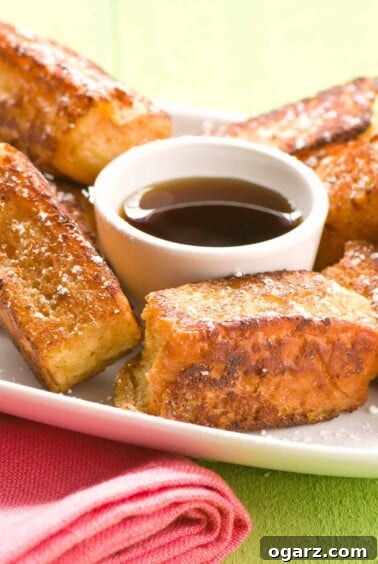 Single serving of Hawaiian French toast sticks with maple syrup, perfect for a casual and fun brunch.