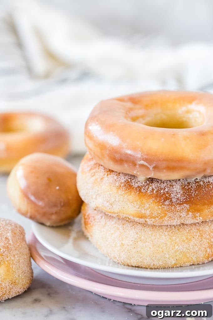 Air-Fried Donut Perfection 2 Stack of Air Fryer Donuts on a plate, both glazed and sugared, ready to be enjoyed