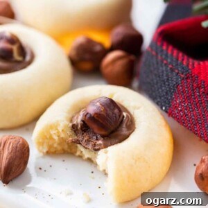 Jam Drop Delights 5 Cookie filled with Nutella with a hazelnut on top, a tempting sweet treat.