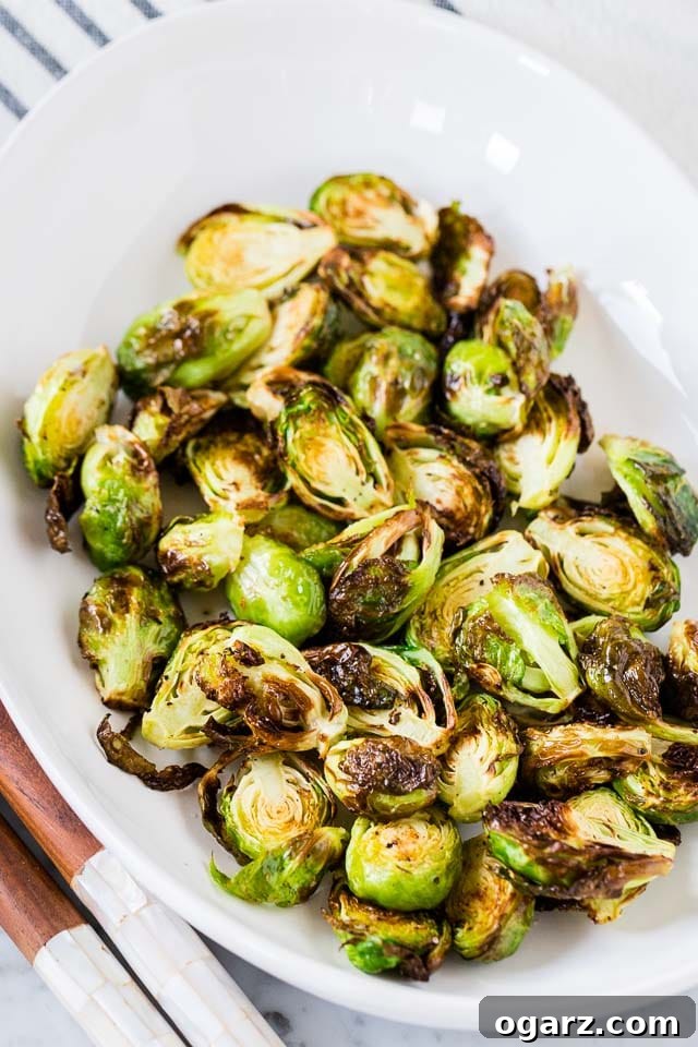 Golden Crispy Air Fryer Brussels Sprouts 4 A serving platter filled with golden-brown Air Fryer Brussels Sprouts, garnished and ready to be enjoyed as a perfect side dish.