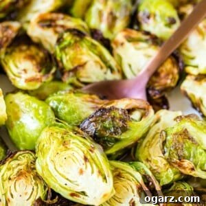 Golden Crispy Air Fryer Brussels Sprouts 5 Close up of roasted Air Fryer Brussels Sprouts with a spoon
