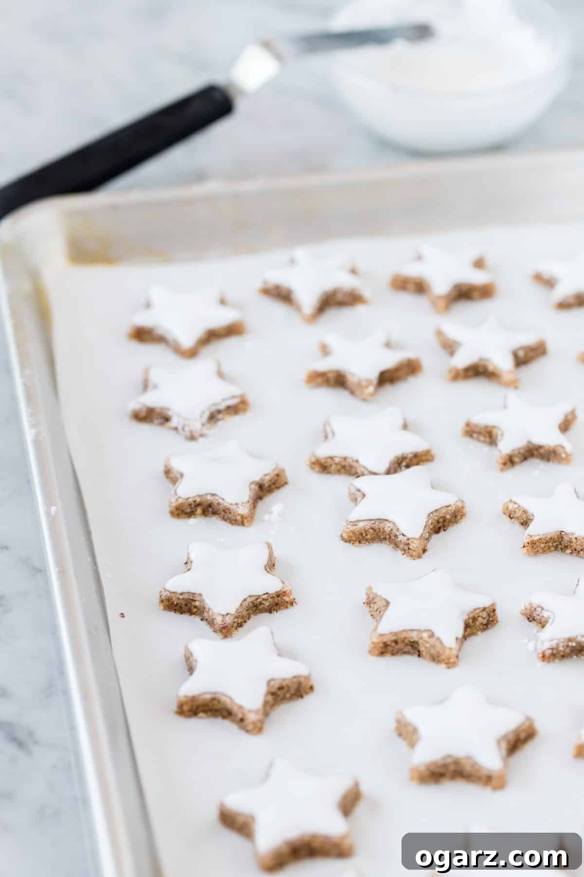 Starry Cinnamon Delights 4 Cinnamon star cookies on a baking tray.