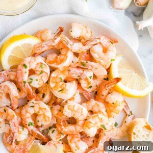 Shrimp on a plate with lemon slices and bread