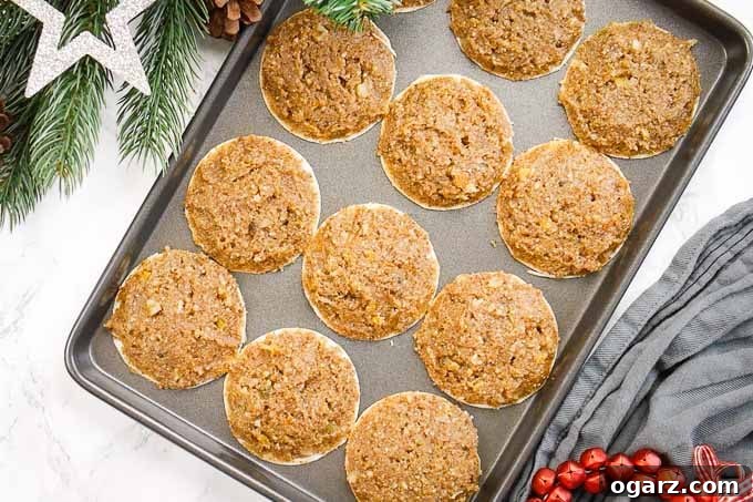 Authentic German Lebkuchen 7 Twelve freshly baked Lebkuchen cooling on a baking sheet, with their edges slightly browned and centers still soft.
