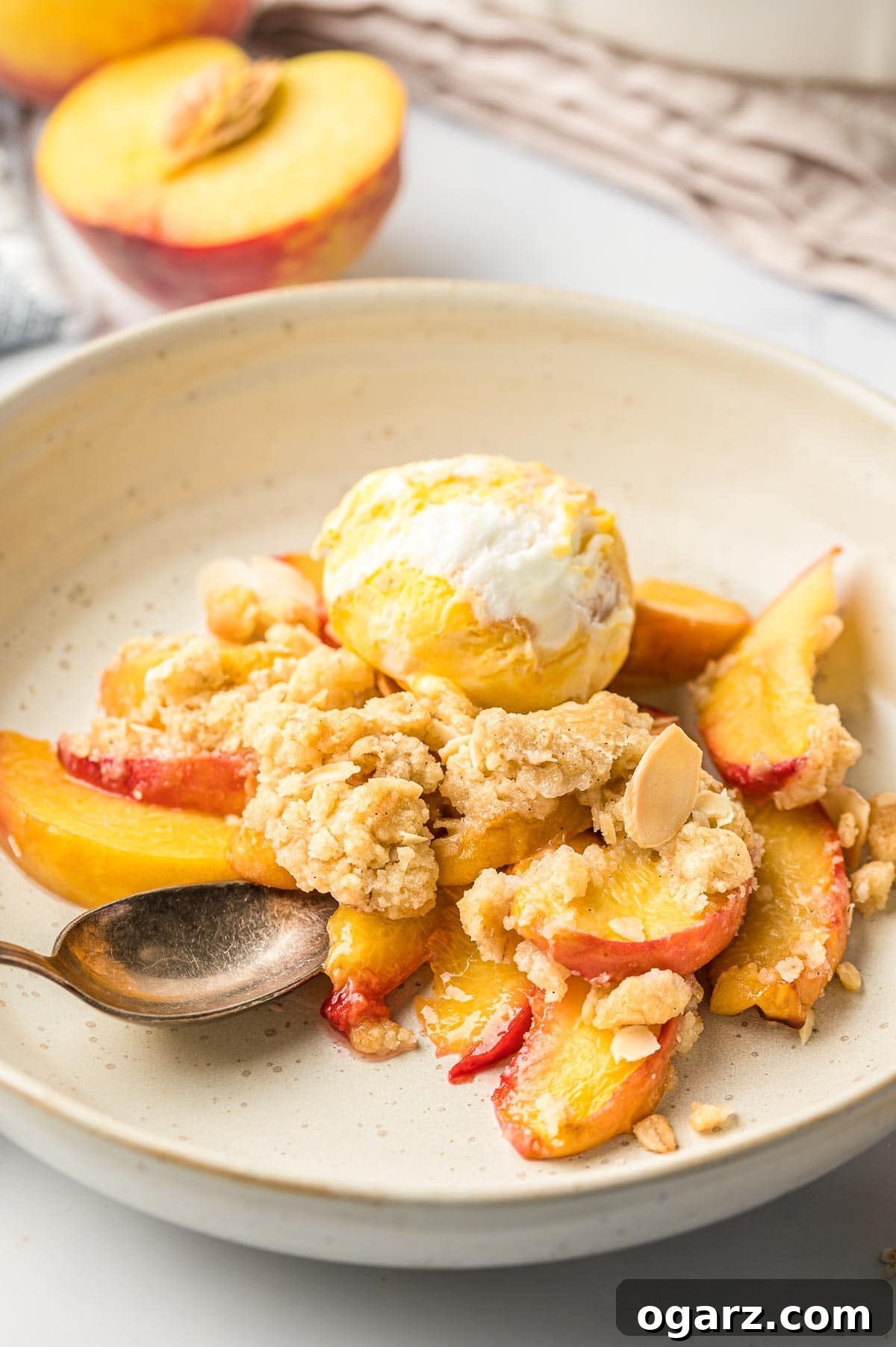 Golden Air Fryer Peach Delight 2 Peach crisp and ice cream on a plate, ready to be enjoyed