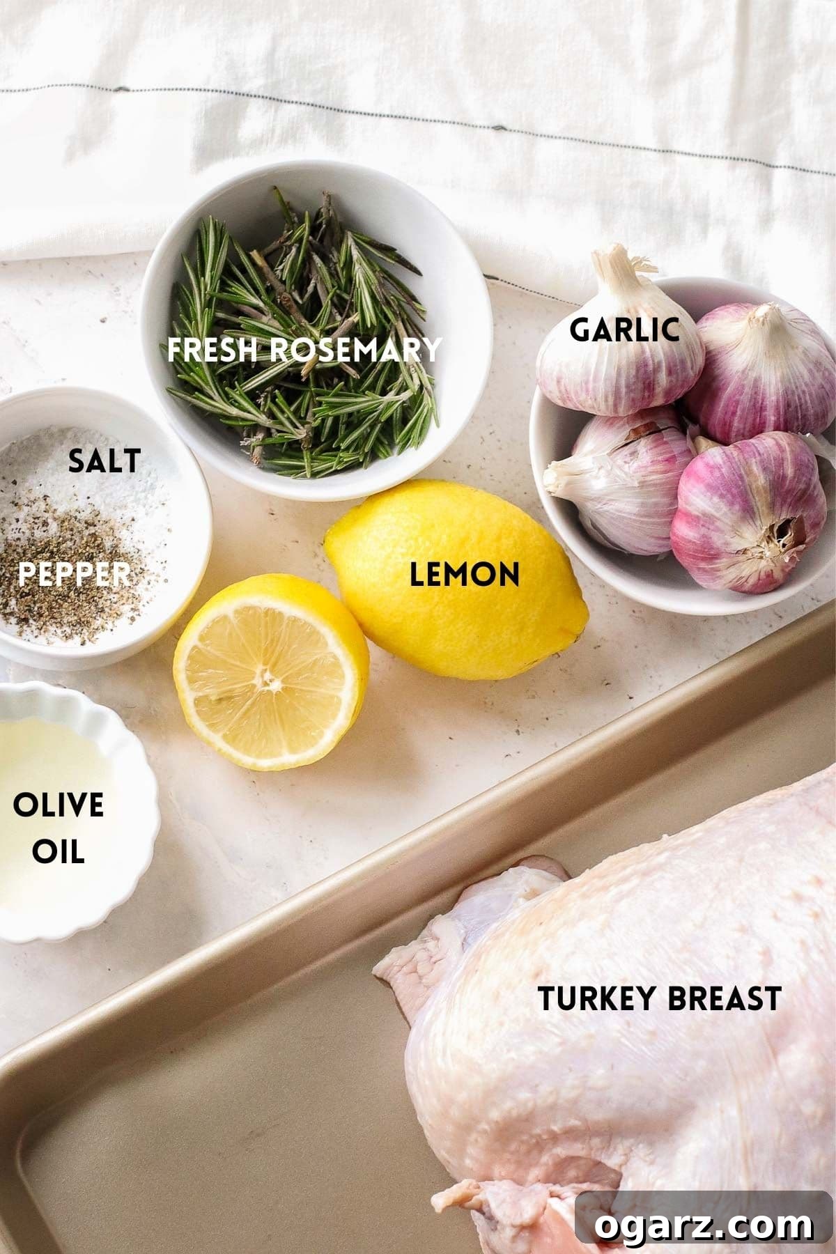 Crispy Air Fryer Turkey Breast 3 A flat lay of fresh ingredients including turkey breast, olive oil, garlic, and rosemary