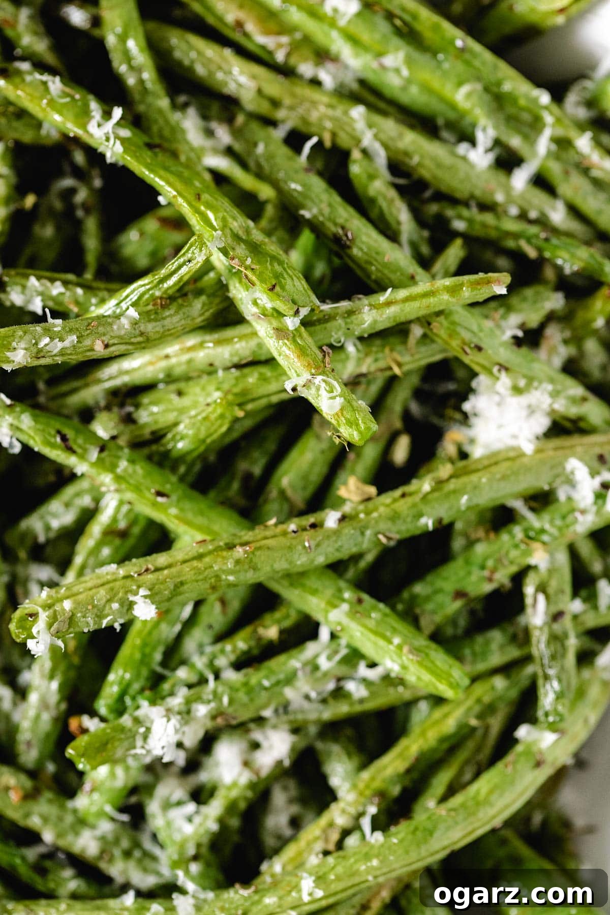 Crispy Air Fryer Green Beans 6 A close-up shot of cooked, perfectly seasoned and slightly blistered green beans, highlighting their appetizing texture.