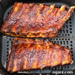A cooked rack of ribs in an air fryer basket