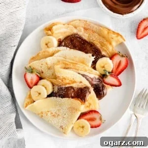 French crepes folded and filled with Nutella on a plate