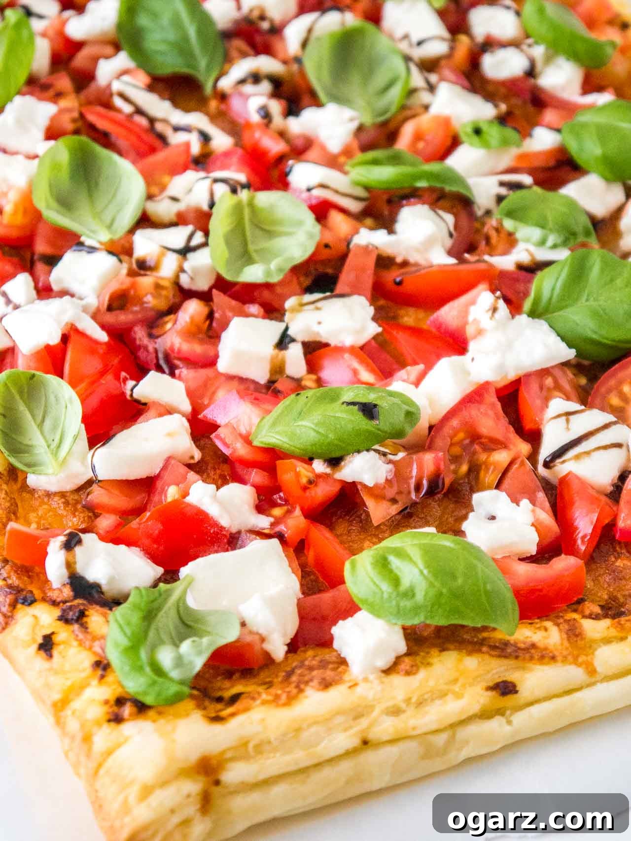 Puff Pastry Pizza with Fresh Tomato and Mozzarella 4 Close-up shot of the mouthwatering Tomato Mozzarella Puff Pastry Pizza, highlighting the vibrant colors and fresh ingredients.