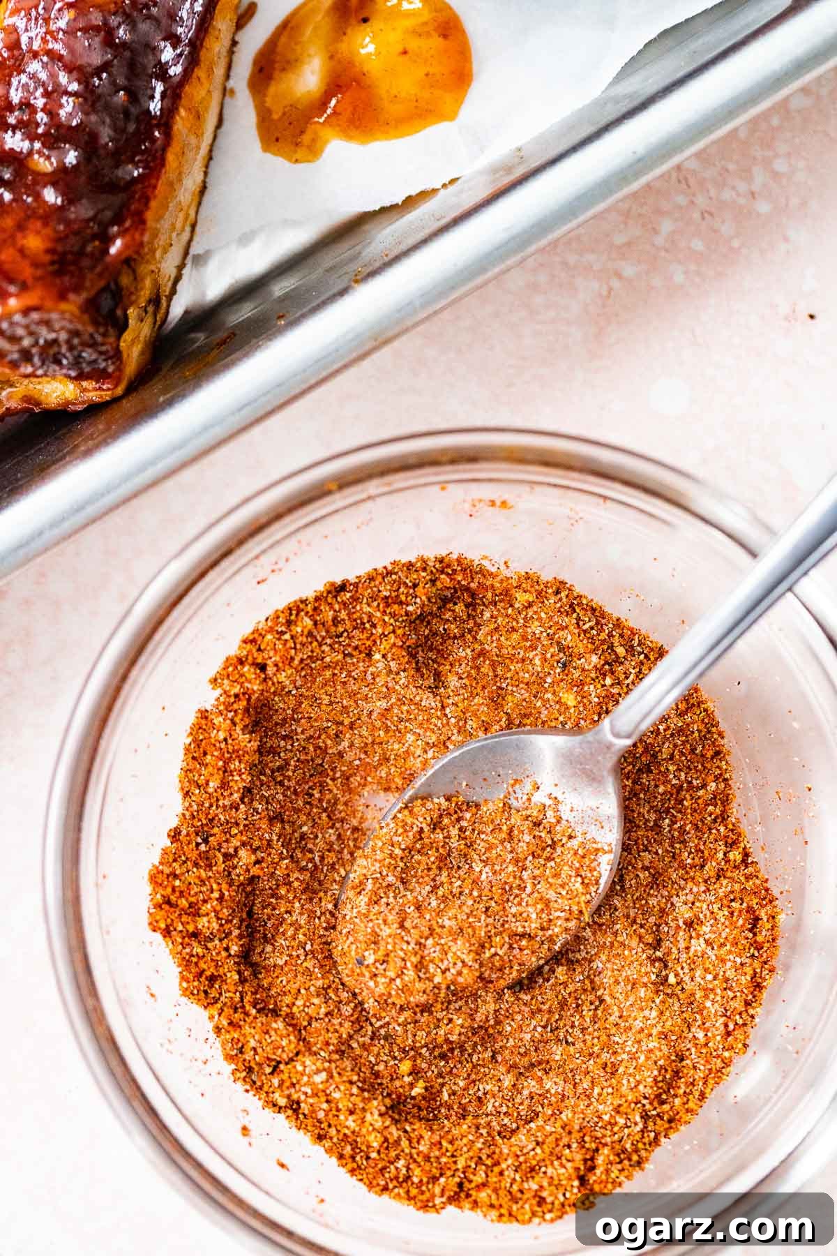 Ultimate Barbecue Blend 5 A bowl of dry rub next to a rack of ribs.