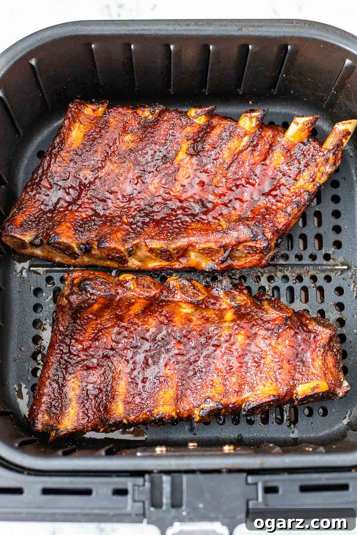 Ultimate Barbecue Blend 6 A cooked rack of ribs in an air fryer basket