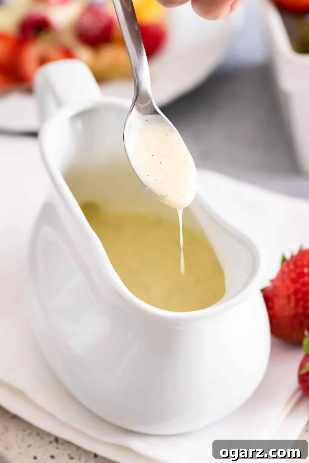 Silken Vanilla Crème 2 Silky vanilla sauce gracefully dripping from a spoon into a elegant bowl, ready to be served over a delightful dessert.