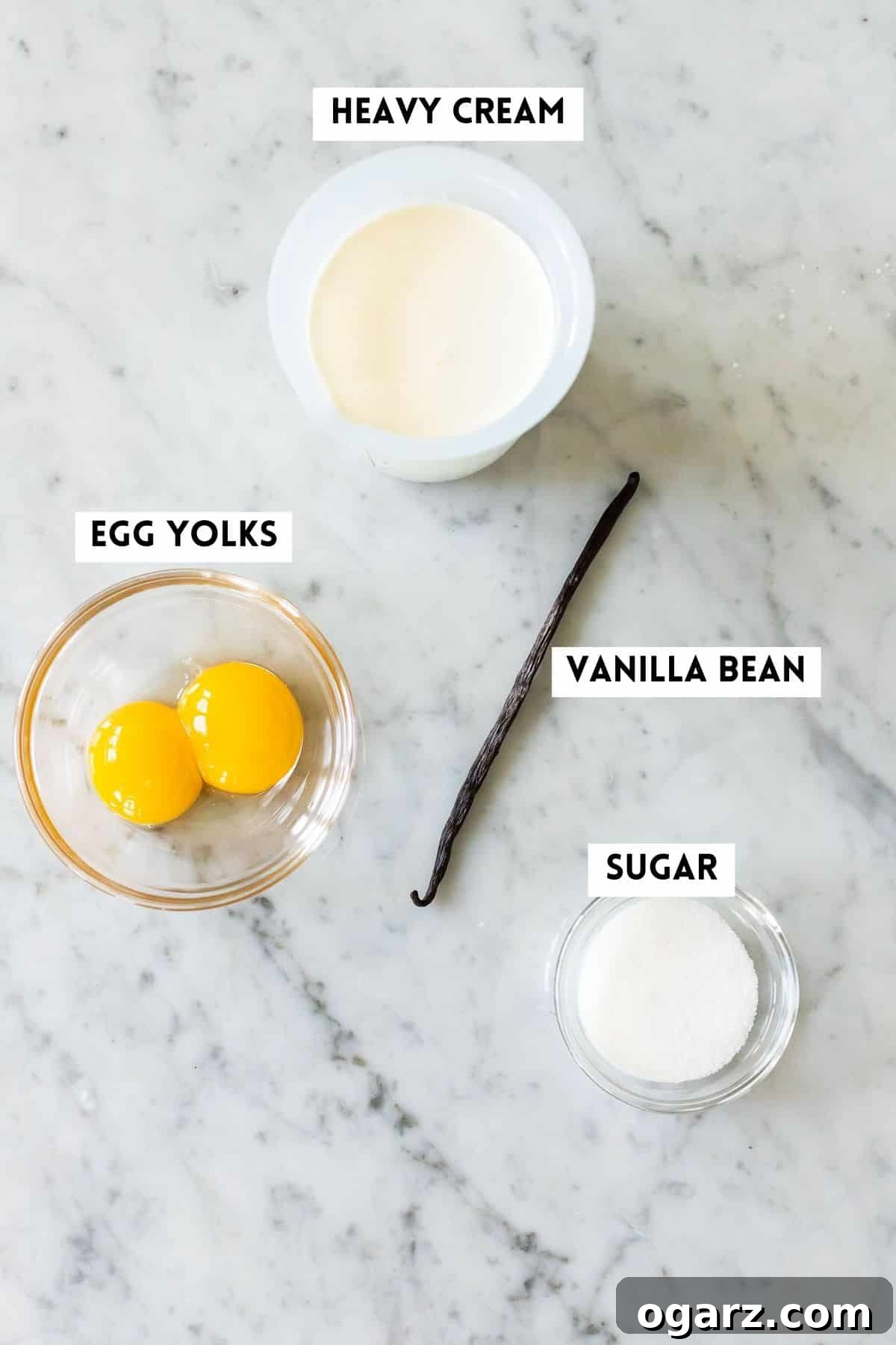 Silken Vanilla Crème 3 Neatly arranged ingredients for making vanilla sauce, including a vanilla bean, egg yolks, sugar, and heavy cream.