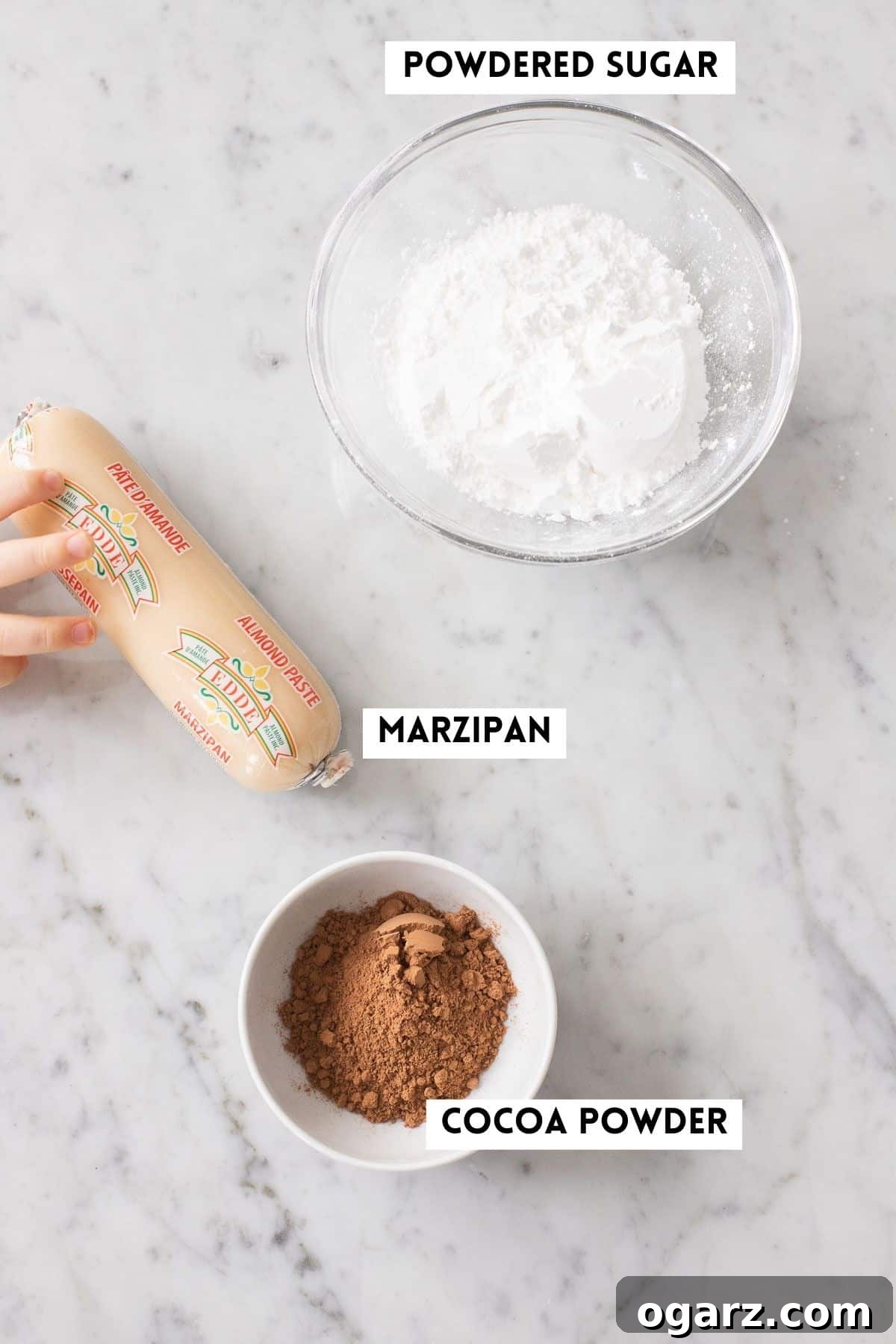 Marzipan Potato Treats 3 Ingredients for making Marzipankartoffeln: marzipan, powdered sugar, and cocoa powder.