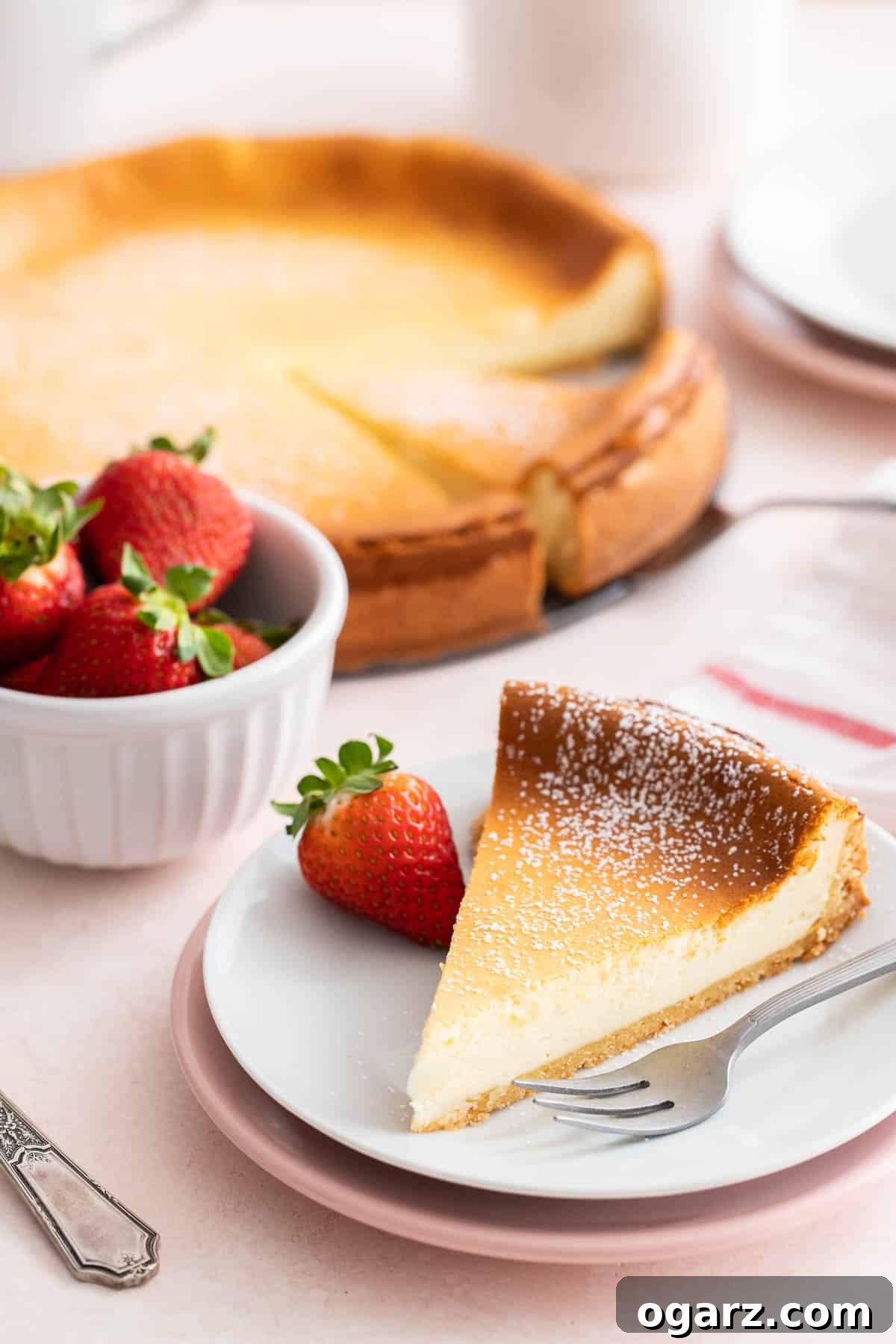 Käsekuchen: The German Cheesecake 8 A majestic German cheesecake positioned on a elegant cake stand, with a single slice meticulously cut and placed in front of it, ready for enjoyment.