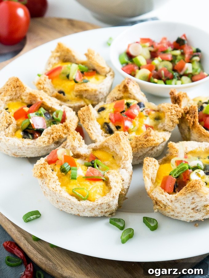 Mexican Fiesta Toast Bites 3 Close-up of freshly baked Cheesy Mexican Toast Cups, showcasing their golden crusts and colorful fillings.