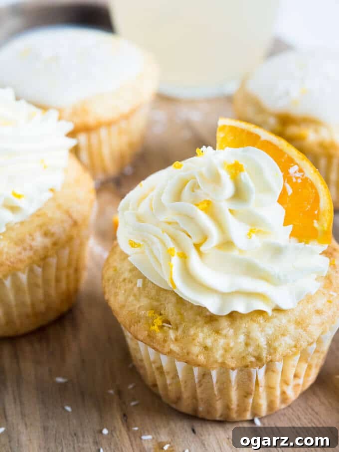 Nostalgic Orange Cream Cupcakes 2 Delicious and refreshing Coconut Orange Creamsicle Cupcakes with a vibrant orange glaze, perfect for summer.