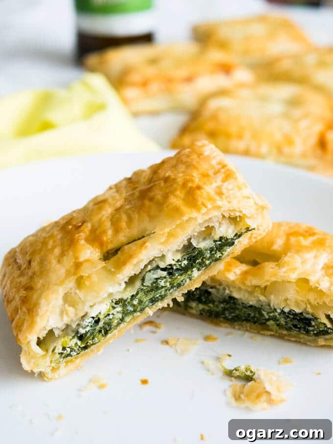 Spinach Ricotta Puff Pastry Pockets 3 A plate of golden and flaky Spinach & Ricotta Puff Pastry Parcels, highlighting their appealing texture.