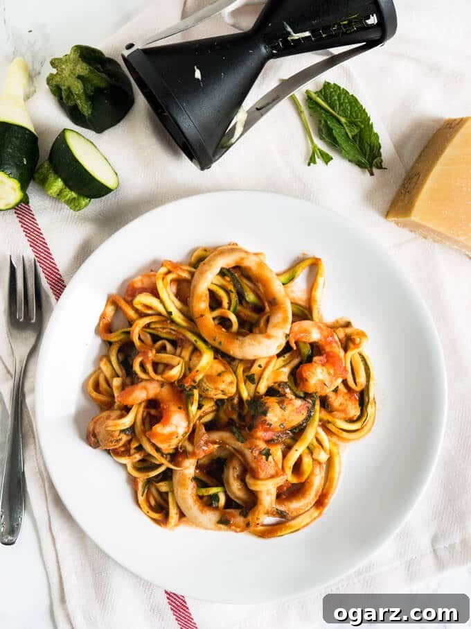 Ocean's Bounty Zucchini Marinara 4 A beautifully presented bowl of Seafood Zucchini Marinara, garnished with fresh basil leaves and grated Parmesan cheese, ready to be enjoyed.