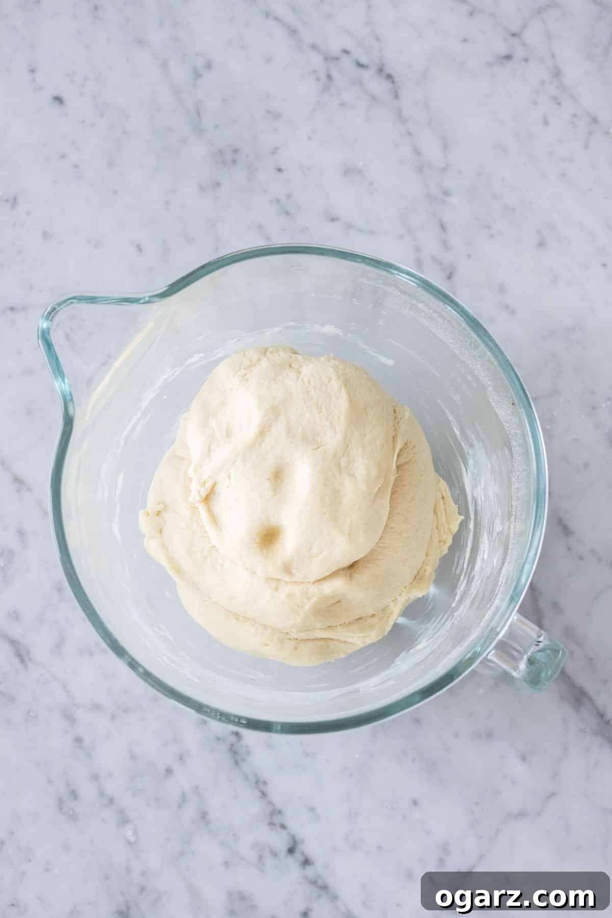 Risen yeast dough in a large pan, spread evenly.