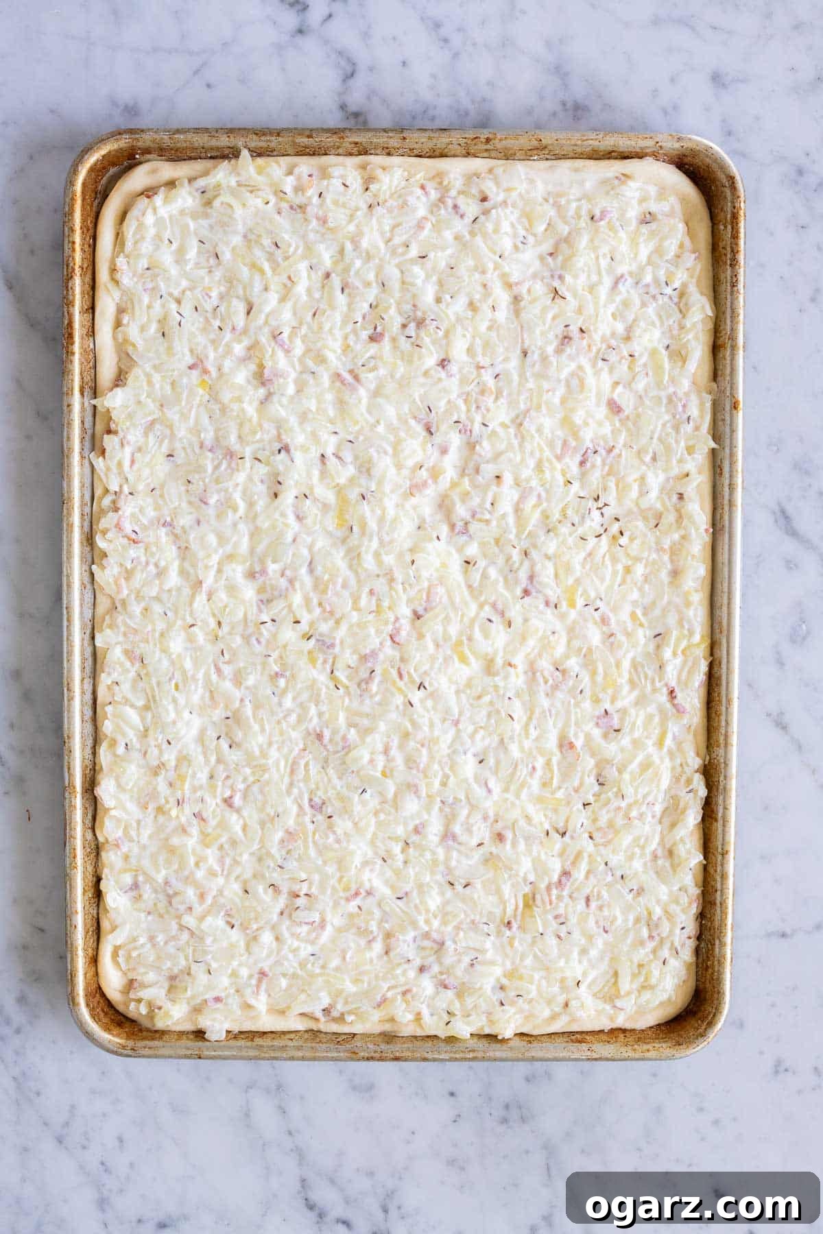 Filling spread evenly on top of the yeast dough on a baking sheet.