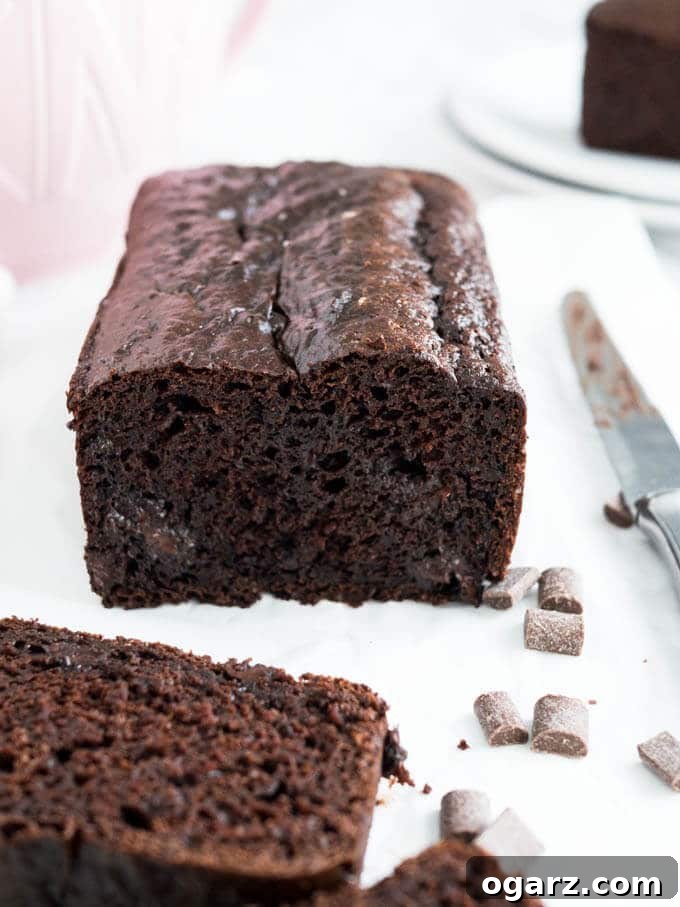 A delectable slice of Double Chocolate Chip Bread, showing off its moist crumb and generous chocolate chips. An ideal treat for any chocolate lover.