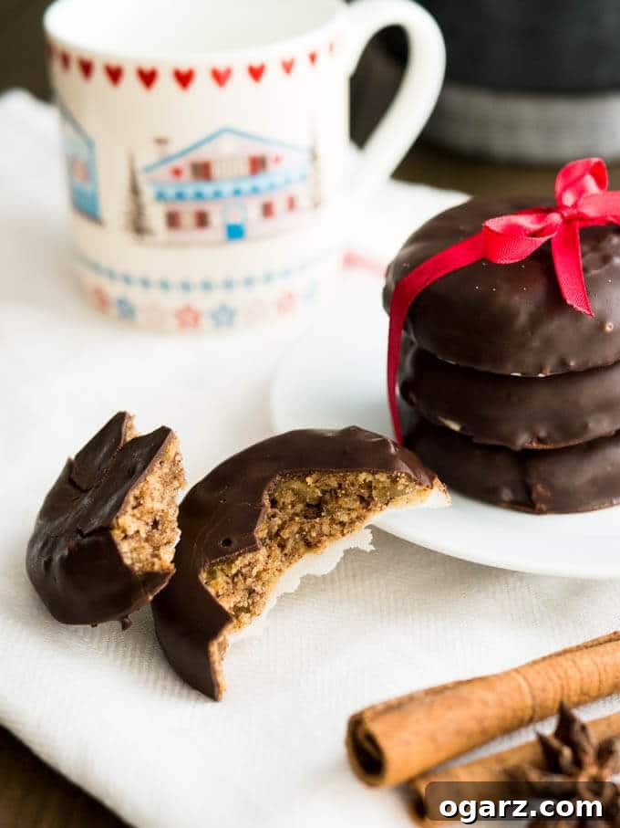 Yuletide Gingerbread Blend 6 A stack of Lebkuchen on a white plate tied together by a red bow. Next to it a coffee mug and a Lebkuchen broken in two pieces.