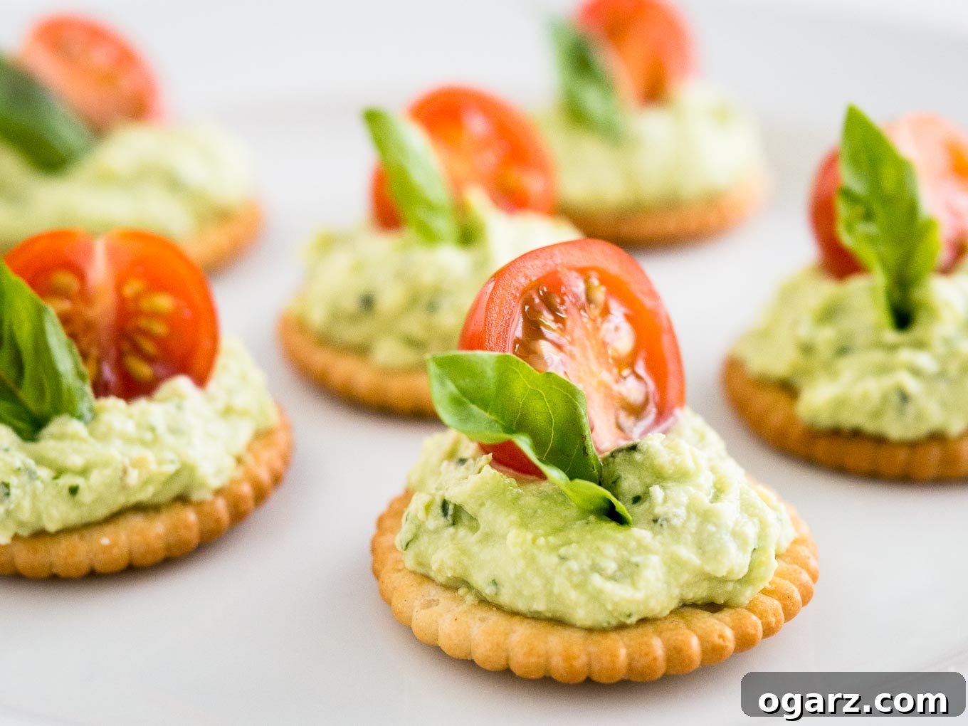 Mediterranean Tomato Feta Poppers 6 Feta Tomato Bites served on a rustic wooden platter, adorned with fresh basil.