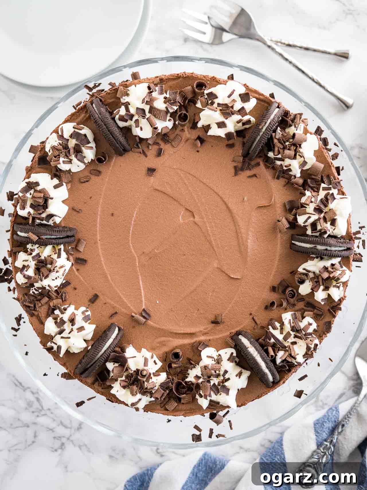 Decadent Chocolate Mousse Dream 5 A no-bake mousse cake garnished with Oreo cookies, whipped cream, and chocolate curls.
