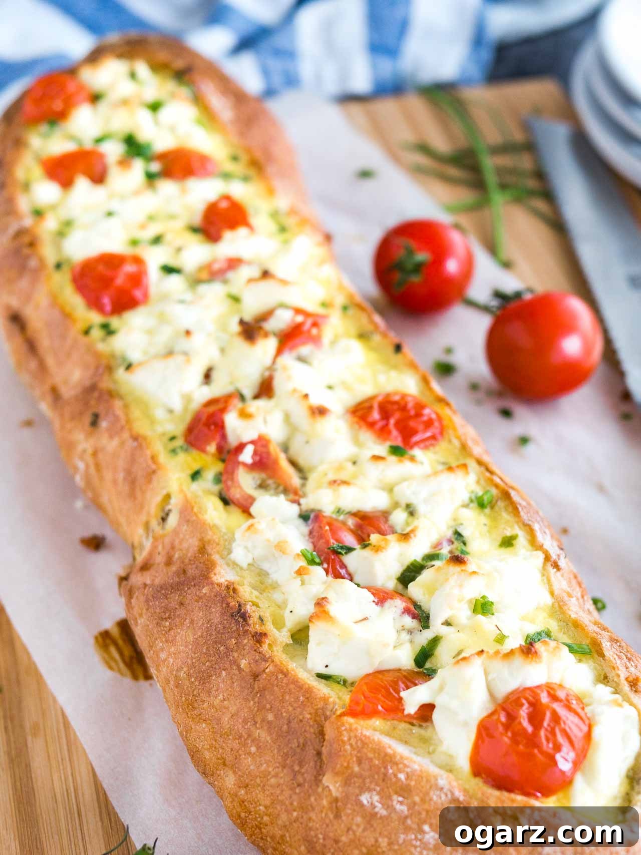 Close-up of the golden-brown crust and vibrant filling of Tomato Feta Stuffed French Bread.