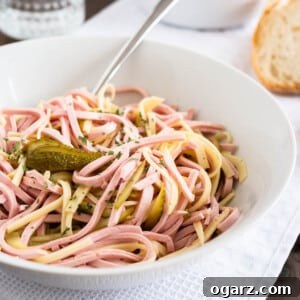 A bowl full of German Sausage Salad.