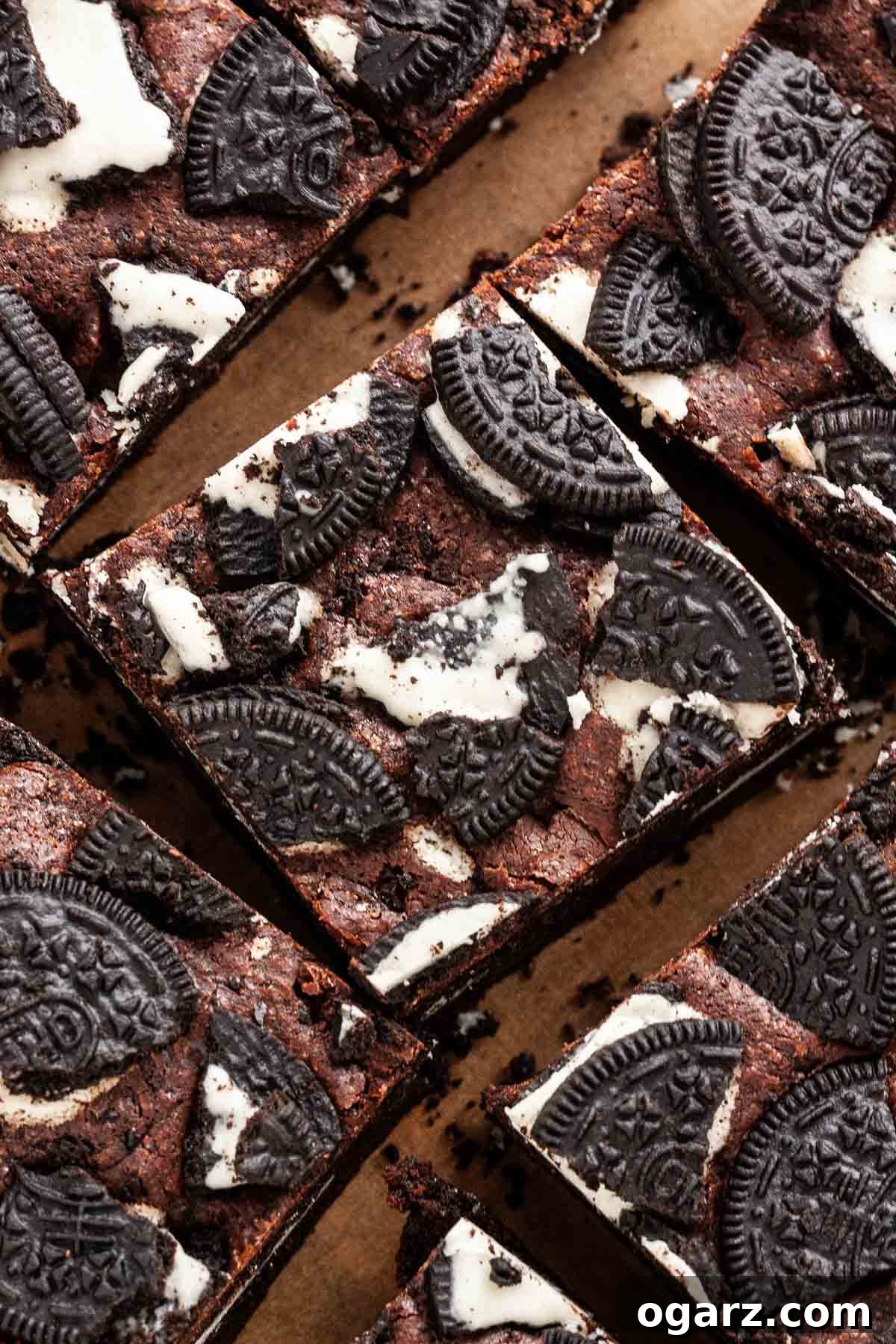 Decadent Oreo Fudge Brownies 2 Sliced brownies on parchment paper.