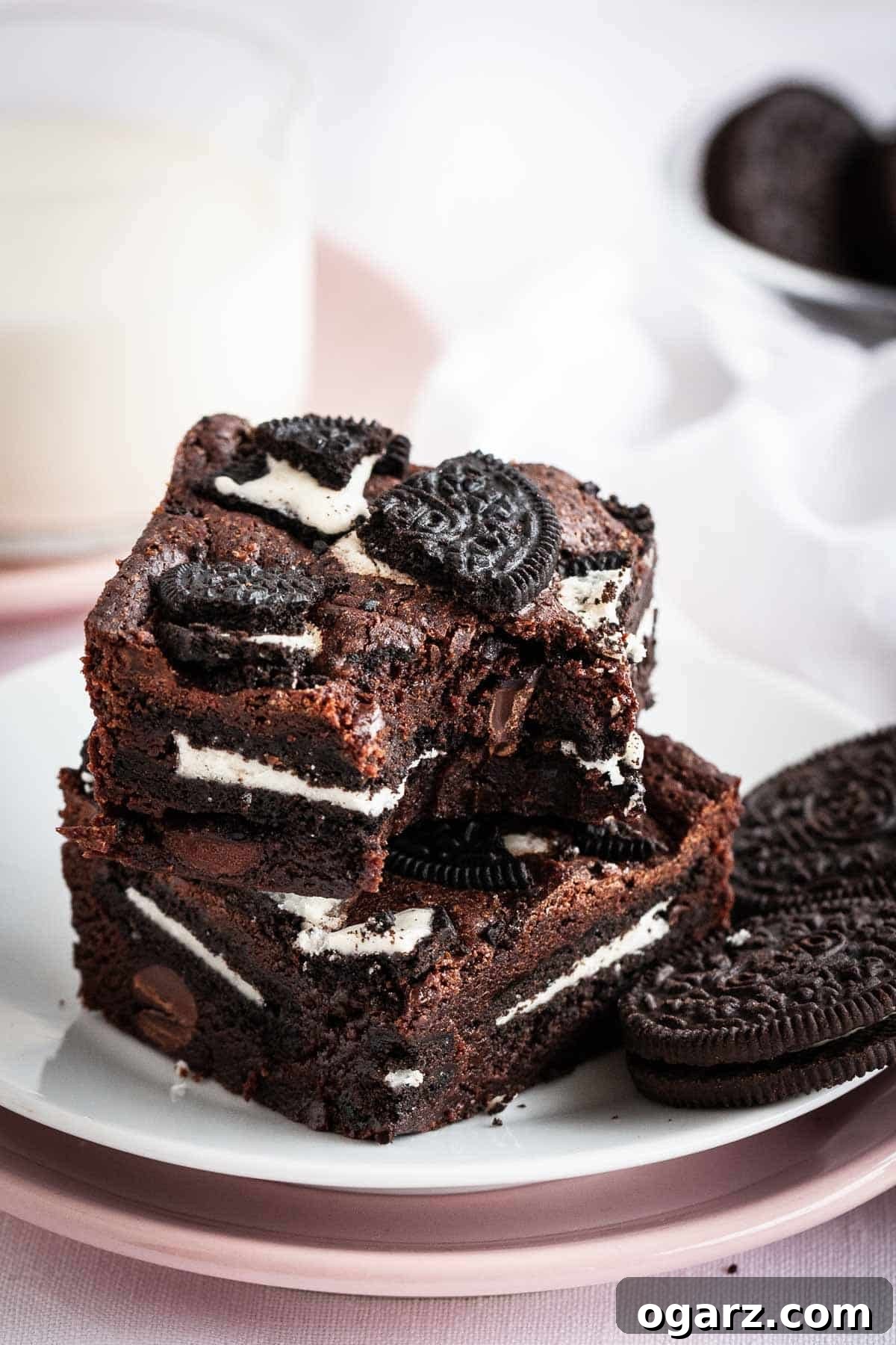 Decadent Oreo Fudge Brownies 6 Brownies on a plate next to a glass of milk.