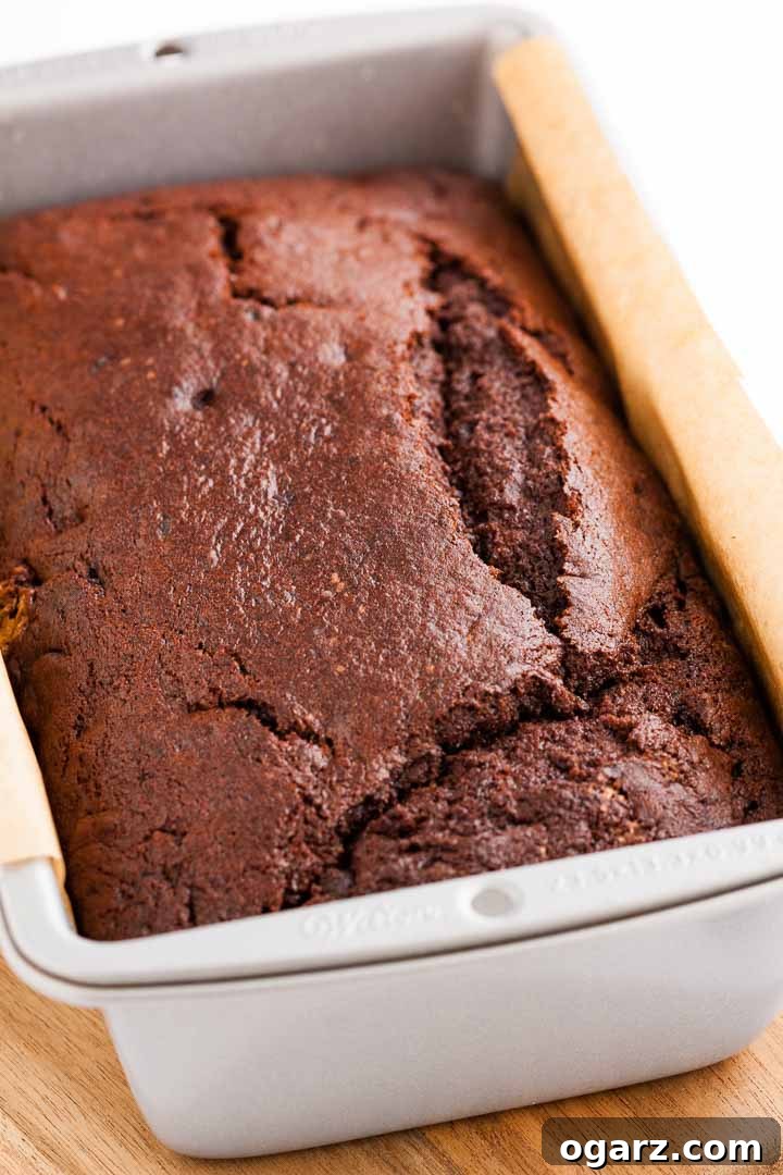 Decadent Chocolate Banana Bread 3 A freshly baked, dark chocolate banana bread nestled within a parchment-lined loaf pan.