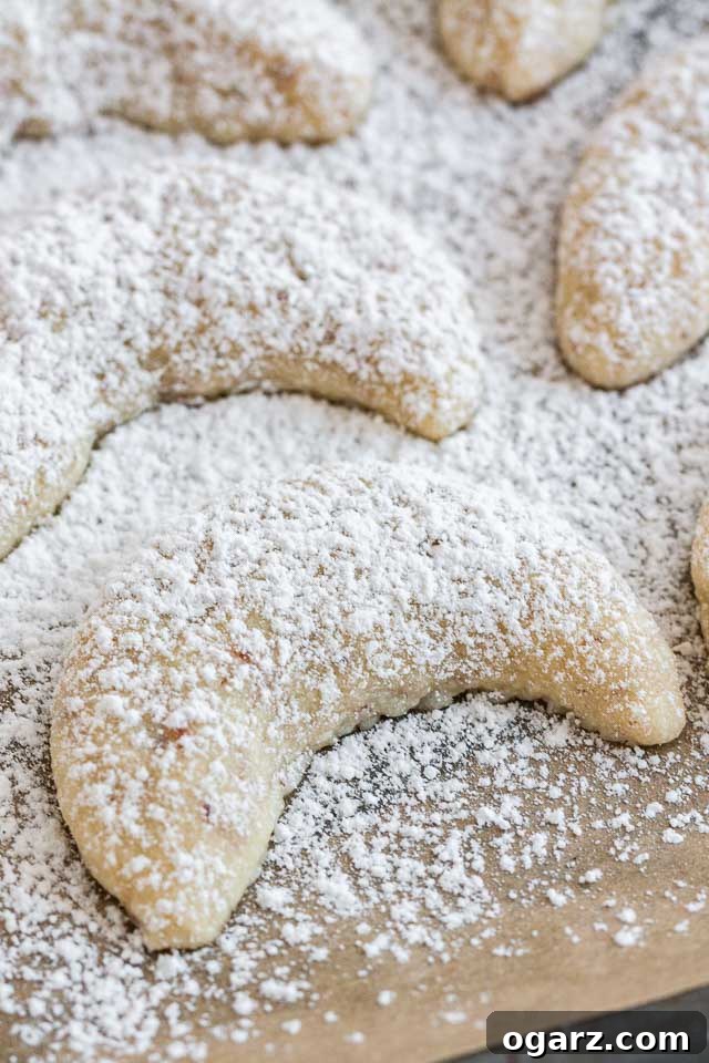 Melt-in-Your-Mouth German Vanilla Crescents 4 Close-up of Vanillekipferl dusted with Powdered Sugar